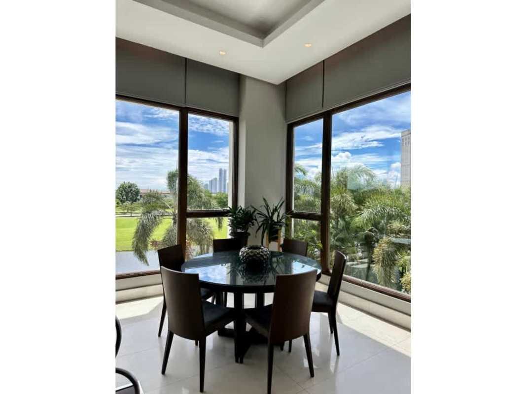 Island kitchen with wood cabinets, stainless appliances and pendant lights in Santa Maria Golf Panama apartment