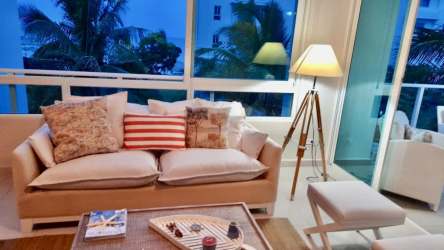 Cozy modern coastal living room with large windows, ocean breeze at Bijao Quarry Heights Panama