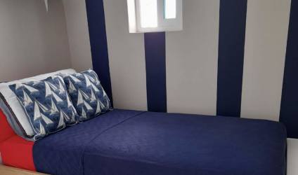 Compact bedroom with nautical theme striped accent wall in Quarry Heights Bijao Panama