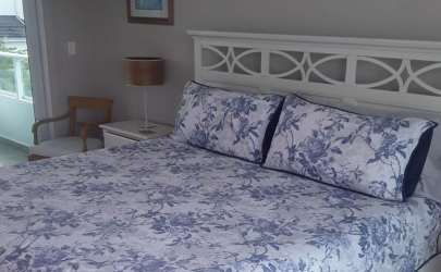 Bright coastal style bedroom floral bedding large window light Bijao Quarry Heights Panama
