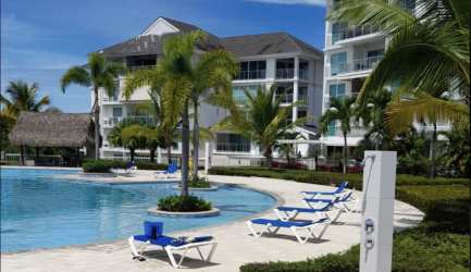 Beachfront resort style pool with palm trees and tropical gardens Bijao Panama condo