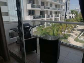 Balcony with table and seating overlooking palm gardens and pool Playa Blanca Resort Panama