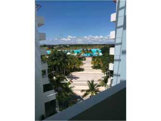 Balcony view from condo overlooking tropical pool and buildings Playa Blanca Resort Panama