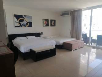 Spacious bedroom with sliding doors to balcony at Playa Blanca Resort condo Panama