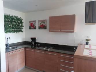 Open concept kitchen-dining area with modern finishes at Playa Blanca Resort condo Panama