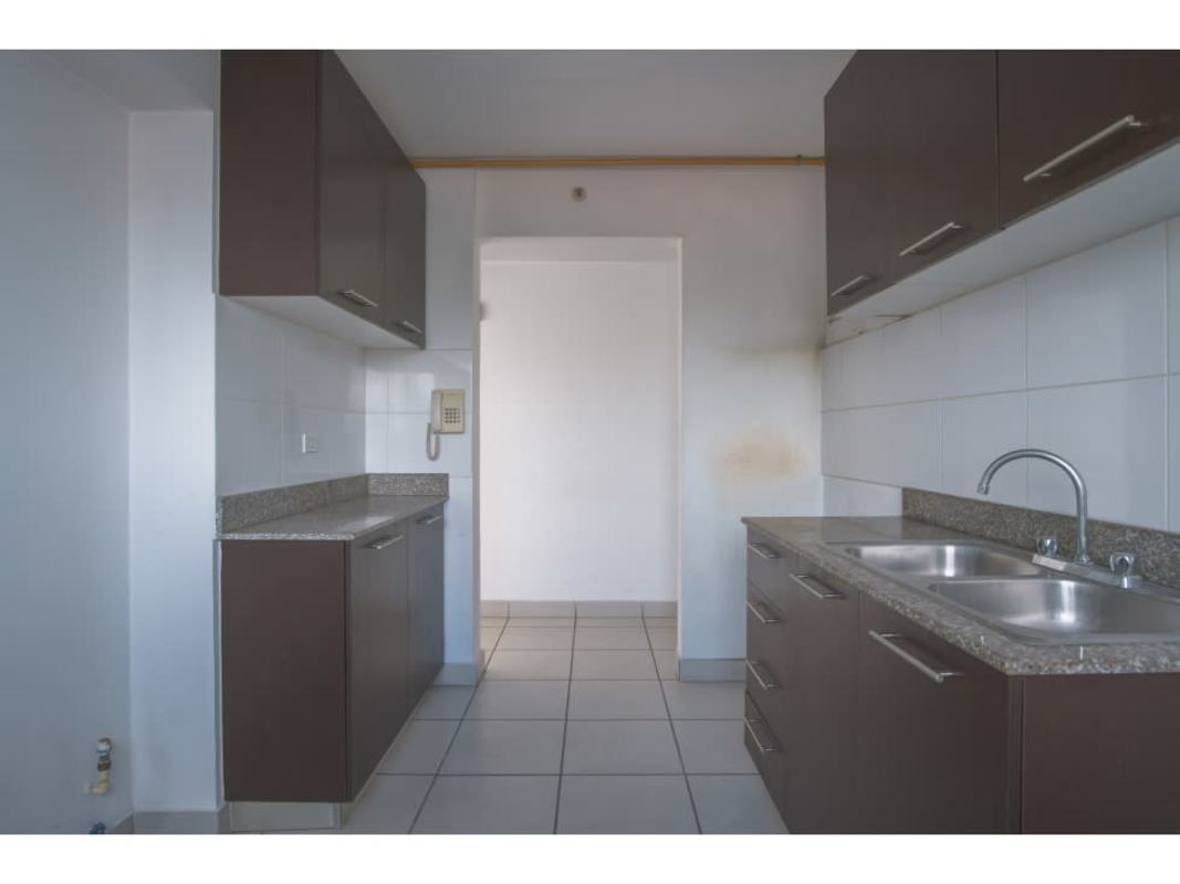 Contemporary kitchen with granite, brown cabinets, tiled backsplash in Panama apartment foreclosure
