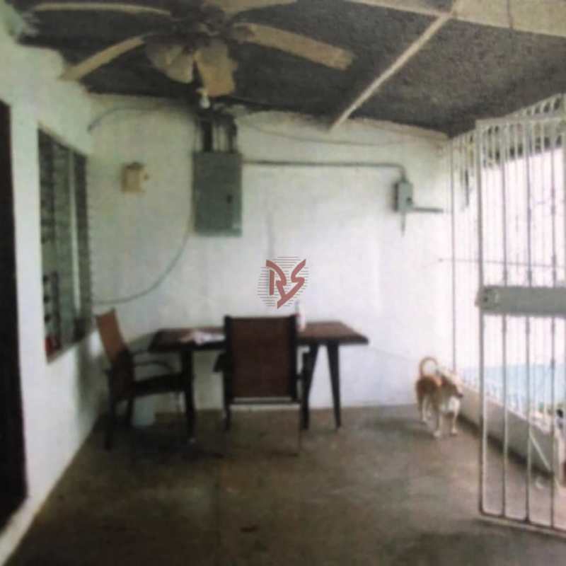 Narrow exterior walkway with metal gate entrance Nueva Concepción Juan Díaz