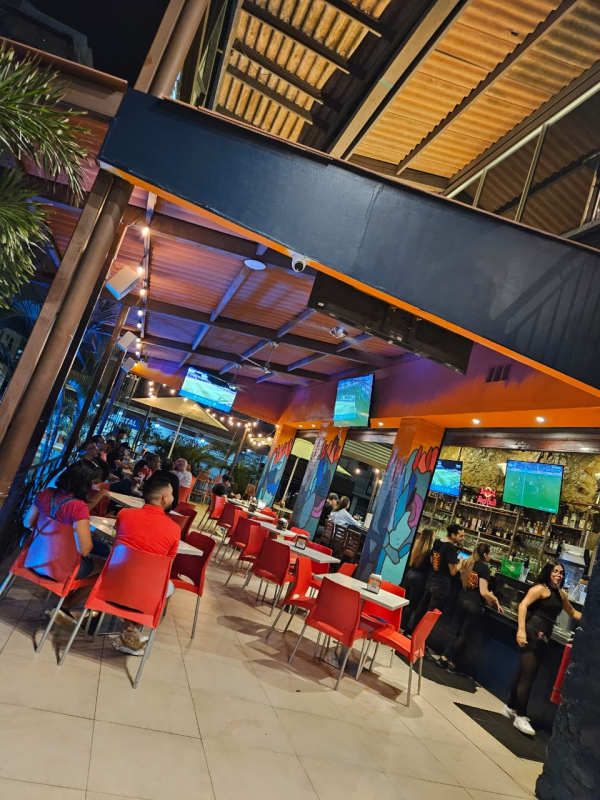 Vibrant outdoor-inspired restaurant with murals, red chairs, multiple TVs, commercial property in Panama