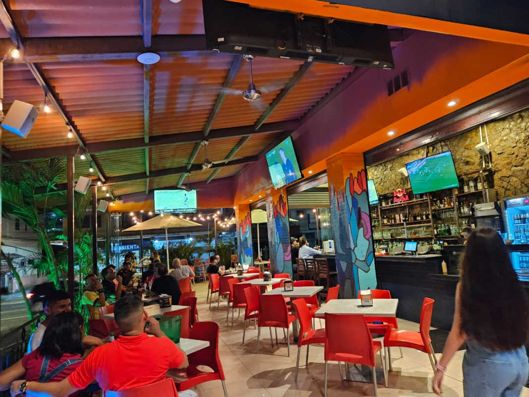 Nightclub bar lounge with neon lights, sectional seating, stone bar counter in a commercial bar for sale in Panama City