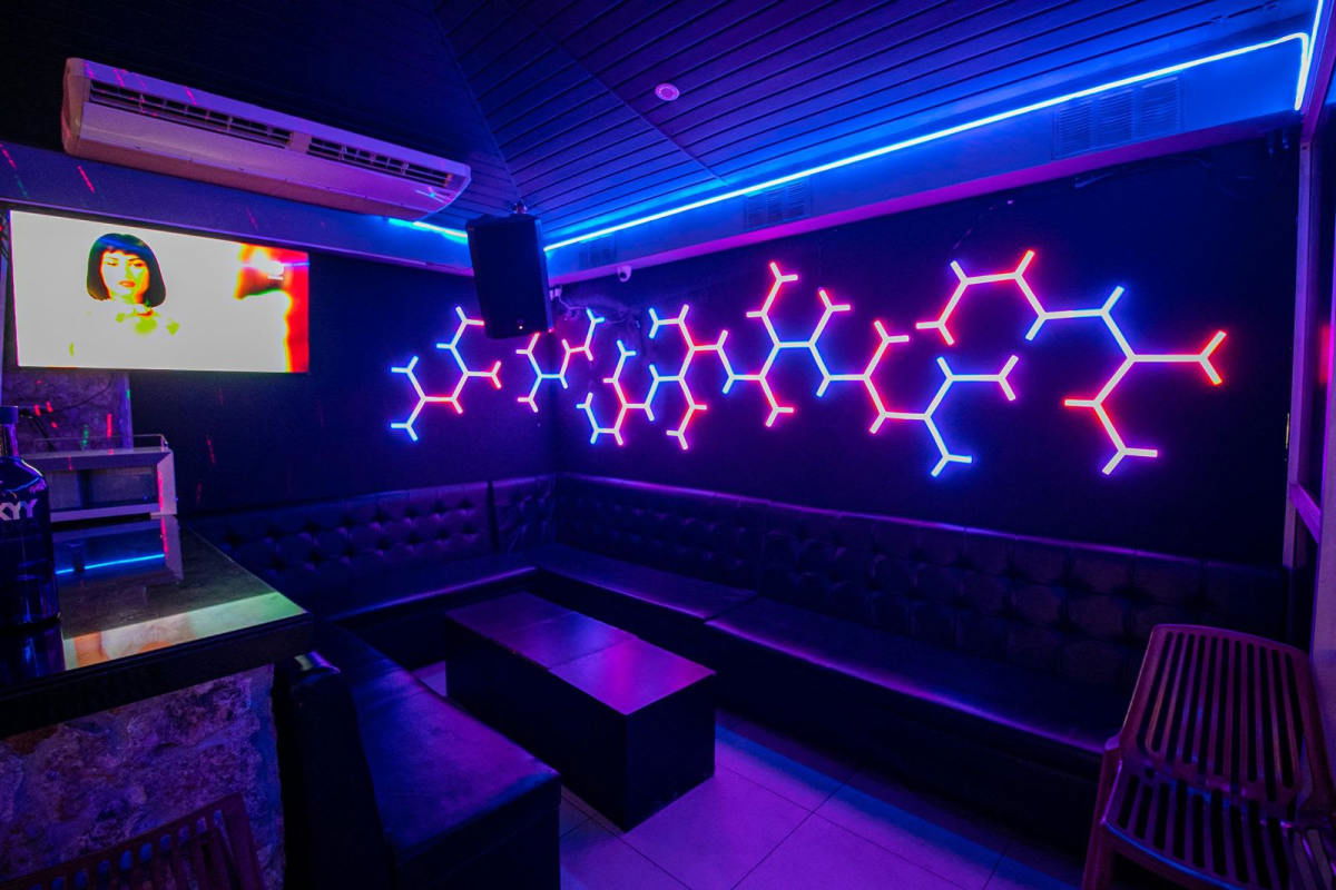 Colorful modern restaurant with purple ceiling, lights, multiple TVs in commercial business for sale Panama
