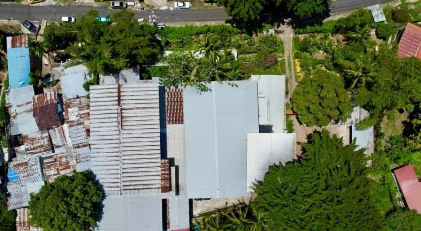 Aerial photo of warehouse complex with metal roofs trees and parking Panama