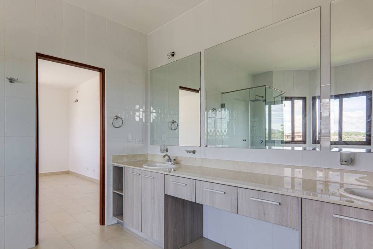 Private grass backyard with high privacy walls new home in Costa Sur Panama City