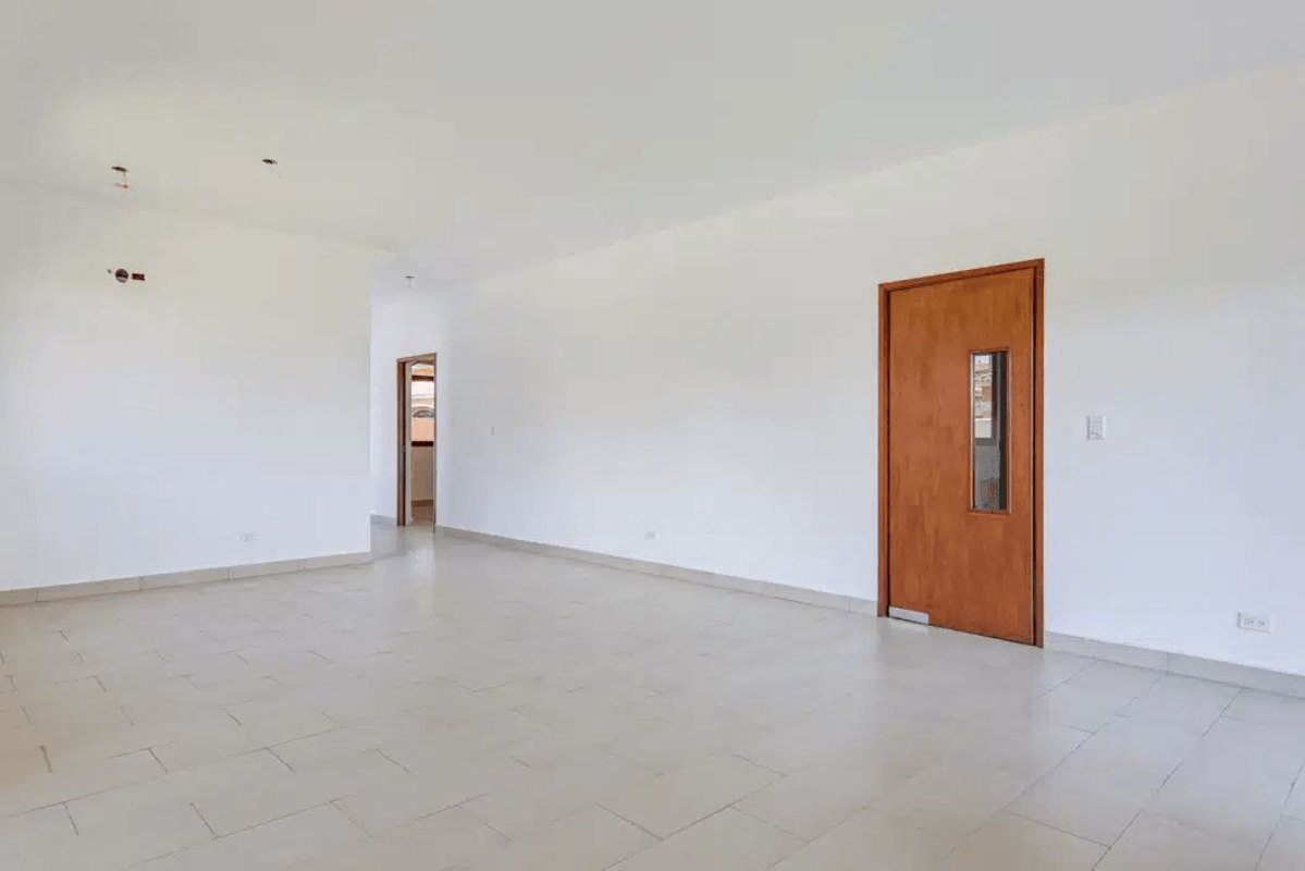 Empty modern bedroom with large window and built-in light wood wardrobe Costa Sur Panama home