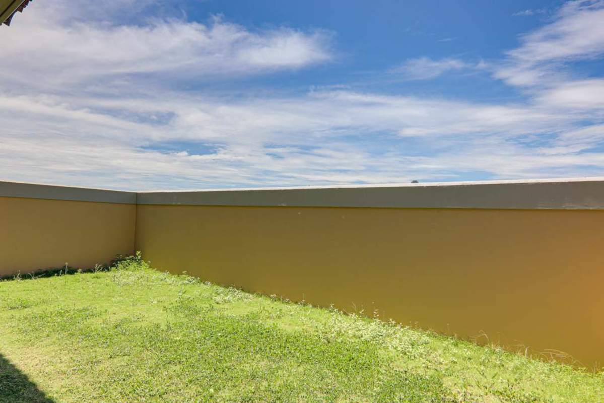 Mediterranean facade with arched windows, covered carport and clay tile roof Costa Sur house for sale