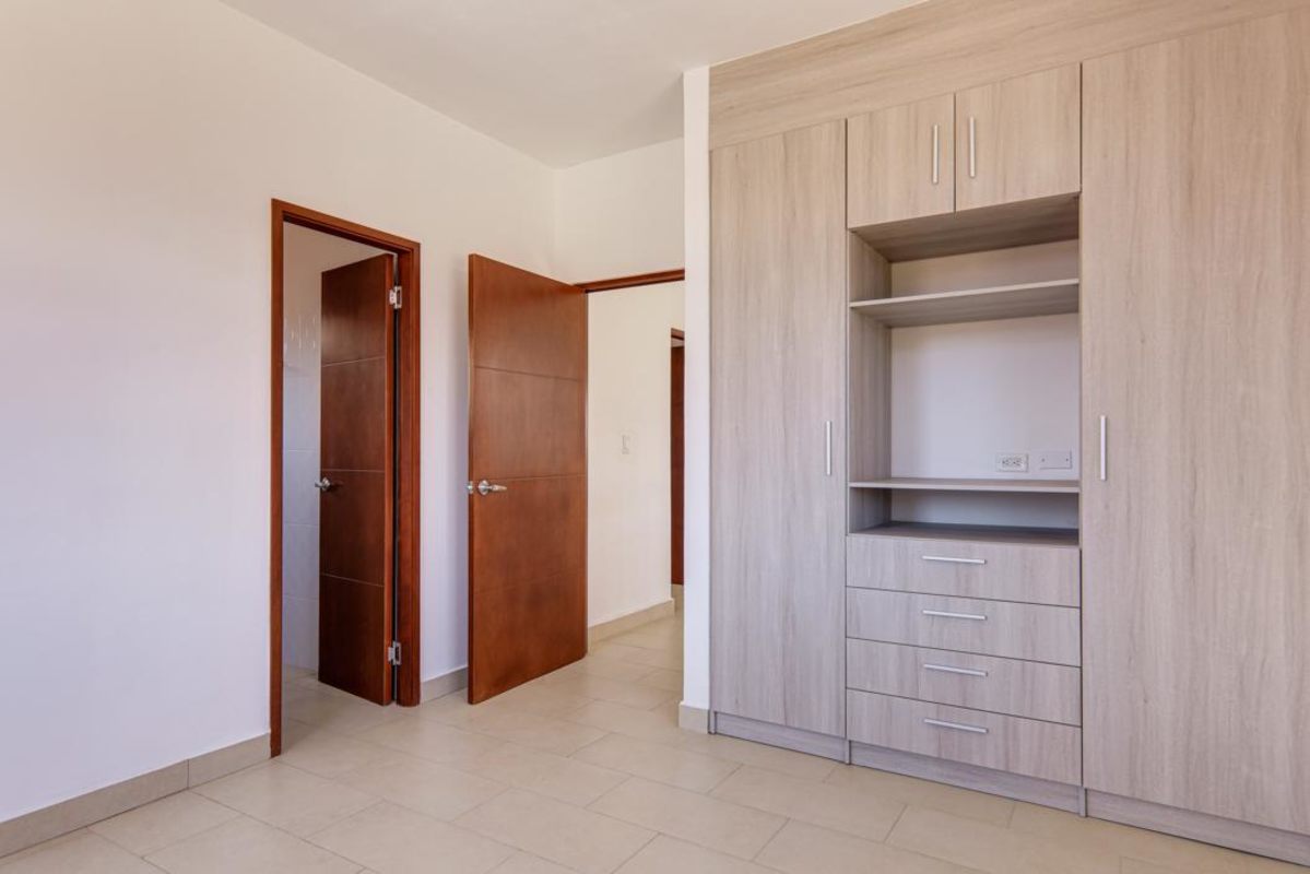 Mediterranean-style facade with terracotta roof and arched windows new home in Costa Sur Panama
