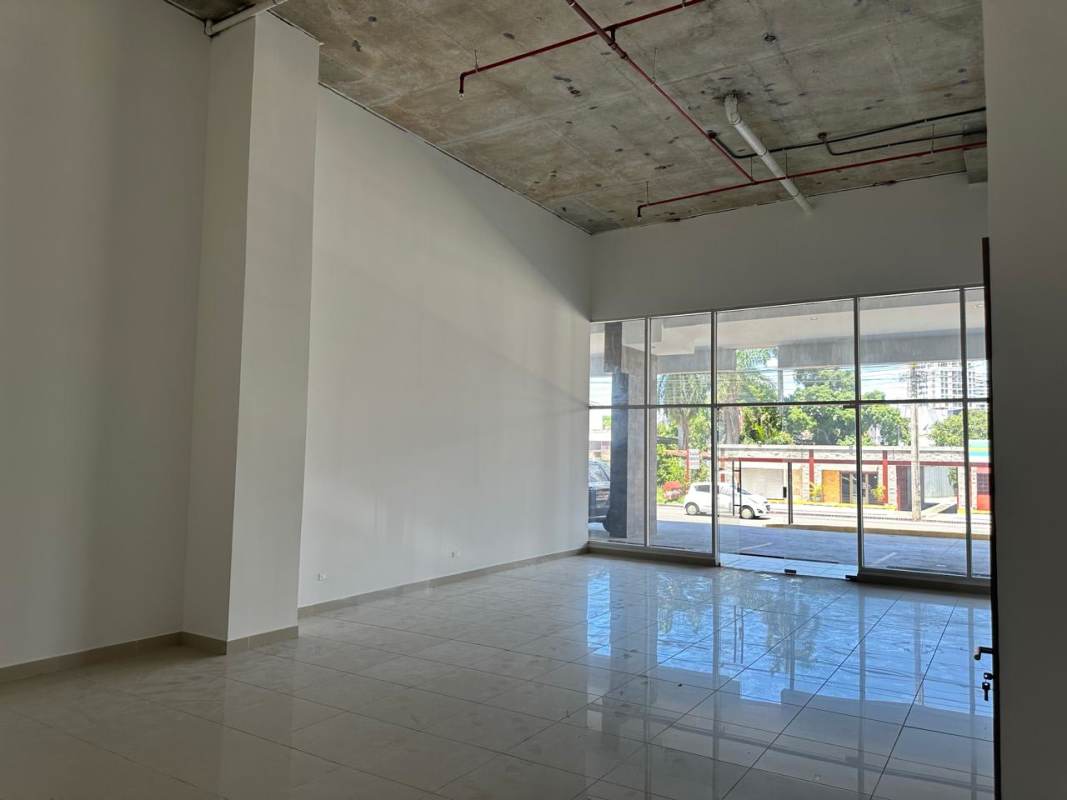 Interior of empty commercial unit with tall ceilings and glass facade in Parque Lefevre Panama