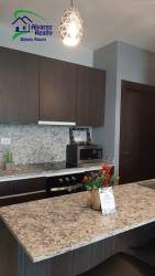 Bedroom with air conditioning, navy bedding, wall art new condo Boquete Gardens David Panama