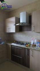 Contemporary living room with large glass doors, ceiling light and polished tile floor in Volcán Panama
