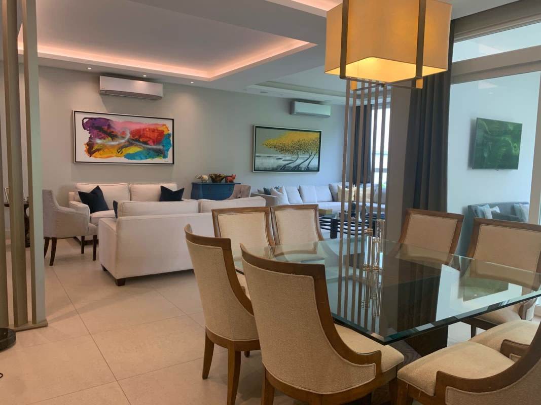 Elegant contemporary living room with large windows in luxury golf community Santa María Panama