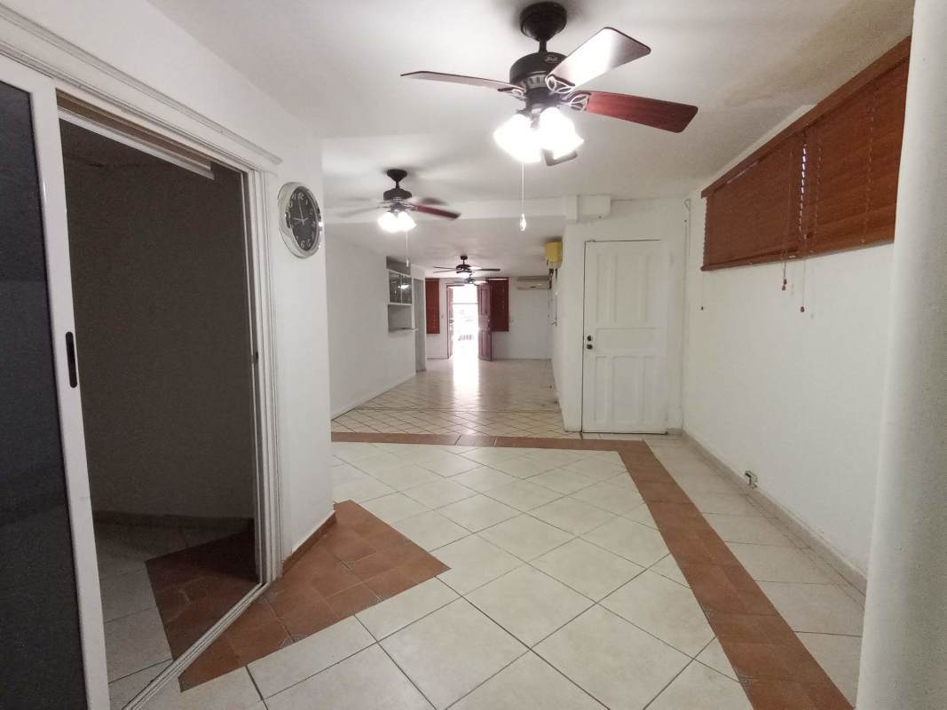 Staircase with ceramic tile steps and wooden handrails inside Panama City house