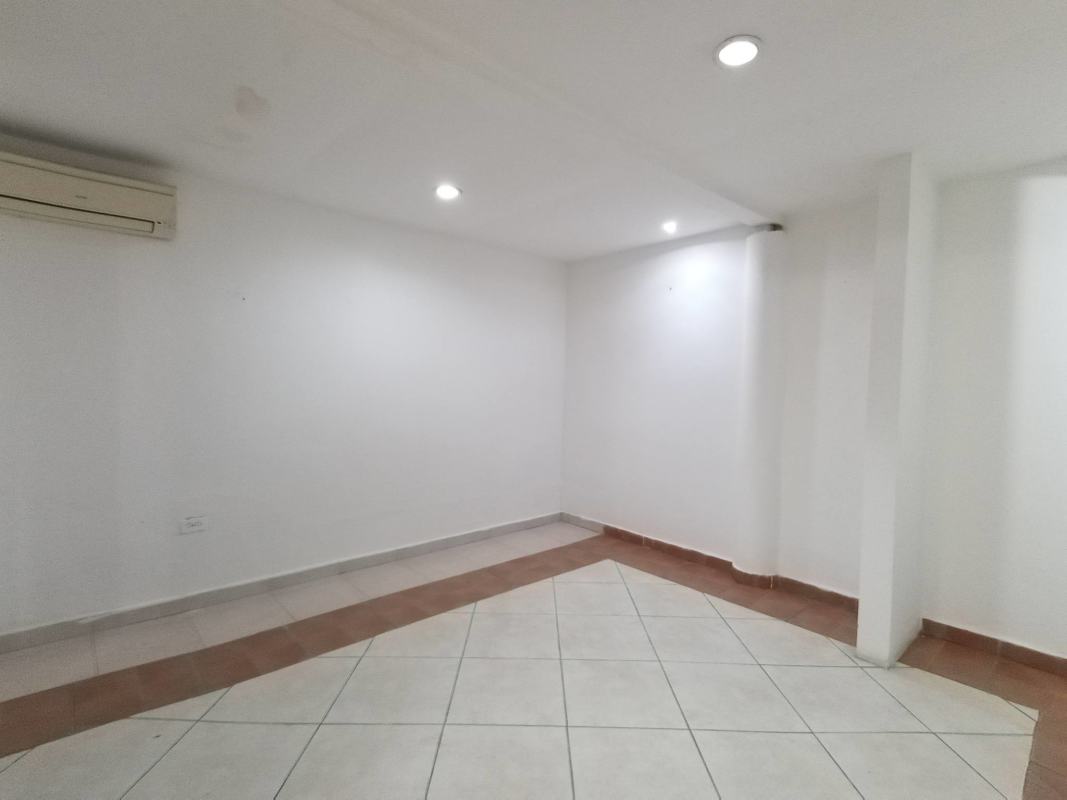 Bright open plan living dining area with tile floor in family house Panama