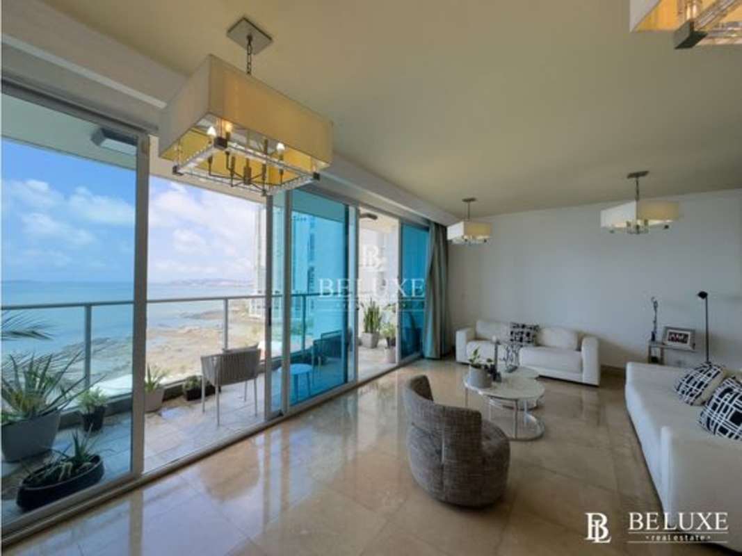 Open concept living and dining with marble flooring and large windows showcasing ocean views in PH Q Tower