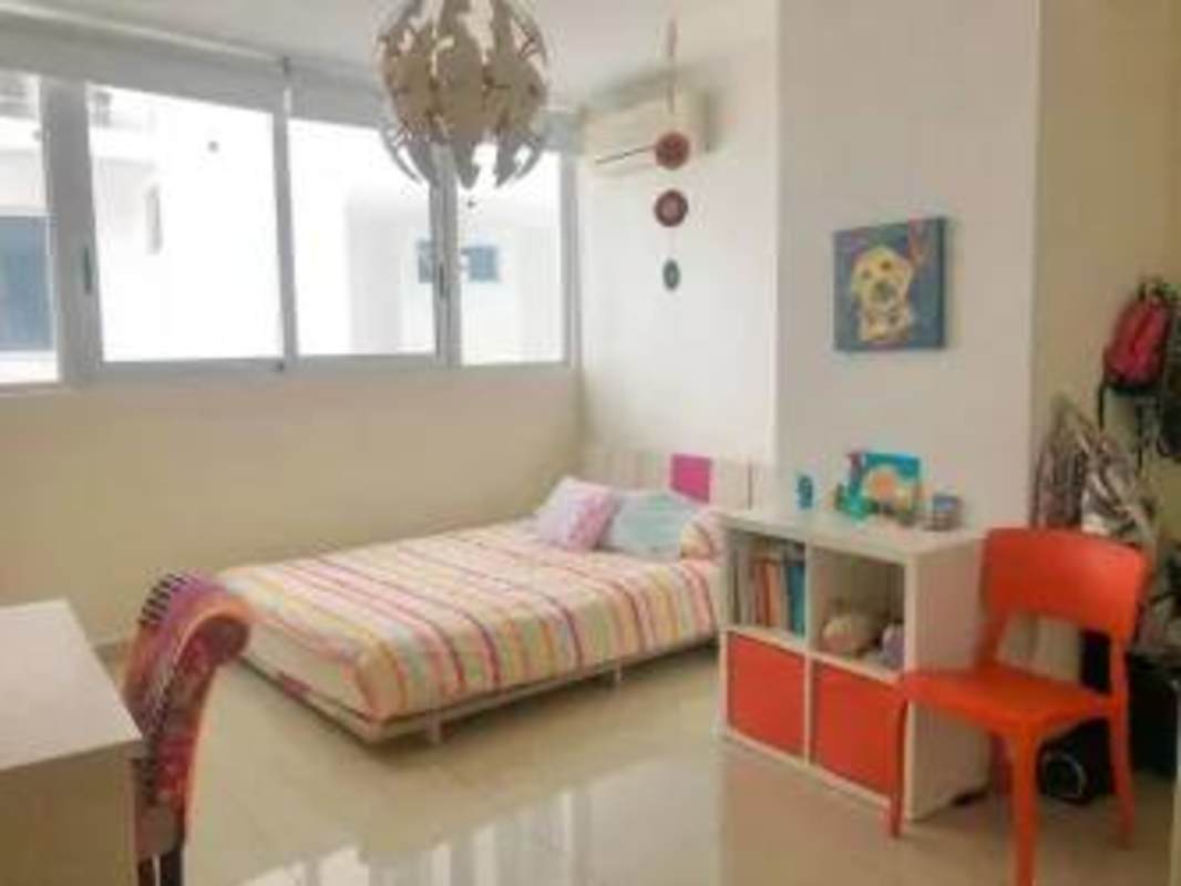Contemporary bedroom with AC, striped bedding, large windows PH Joy Tower Coco del Mar Panama
