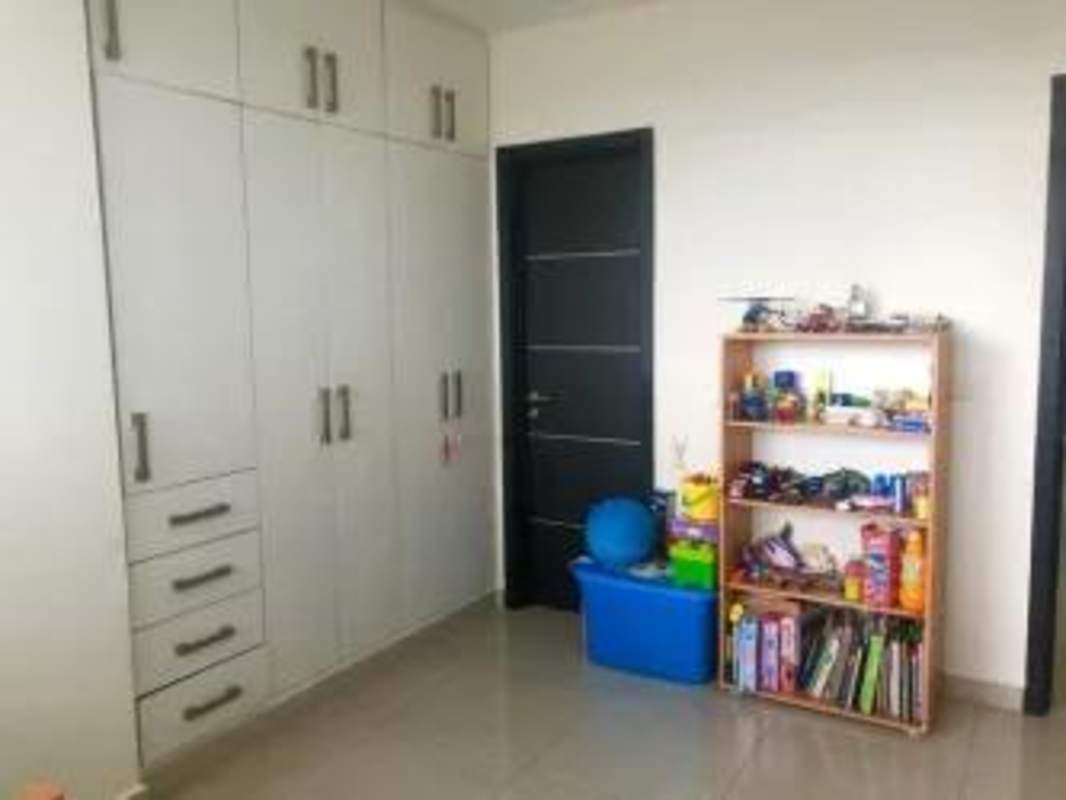 Bedroom with wardrobe, tiled floors, bookshelf storage in PH Joy Tower Coco del Mar Panama