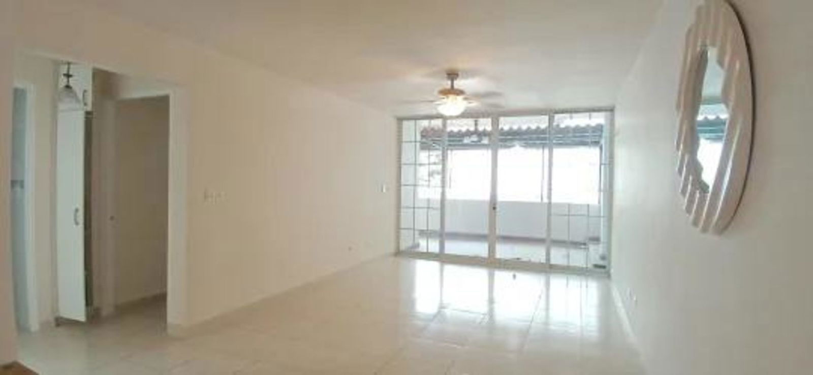 Living room interior with large windows and ceramic tile floors in Betania apartment PH Plaza Camino Real