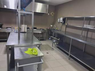 Modern tiled public restrooms at commercial restaurant with partitions, sinks, and decorative accents Panama