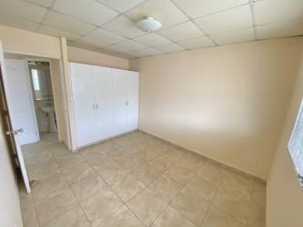 Bedroom featuring built-in closet, window, tile flooring in Panama family house