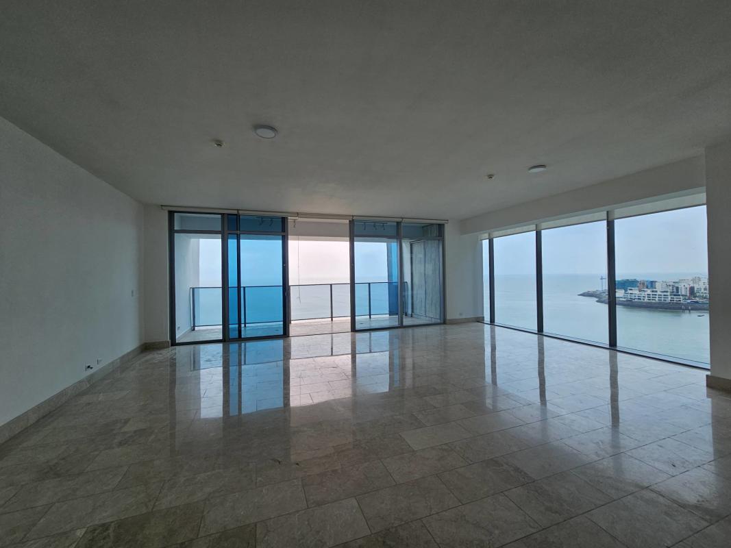 Open living area with marble floors, floor-to-ceiling windows, balcony in PH Grand Tower Punta Pacifica Panama