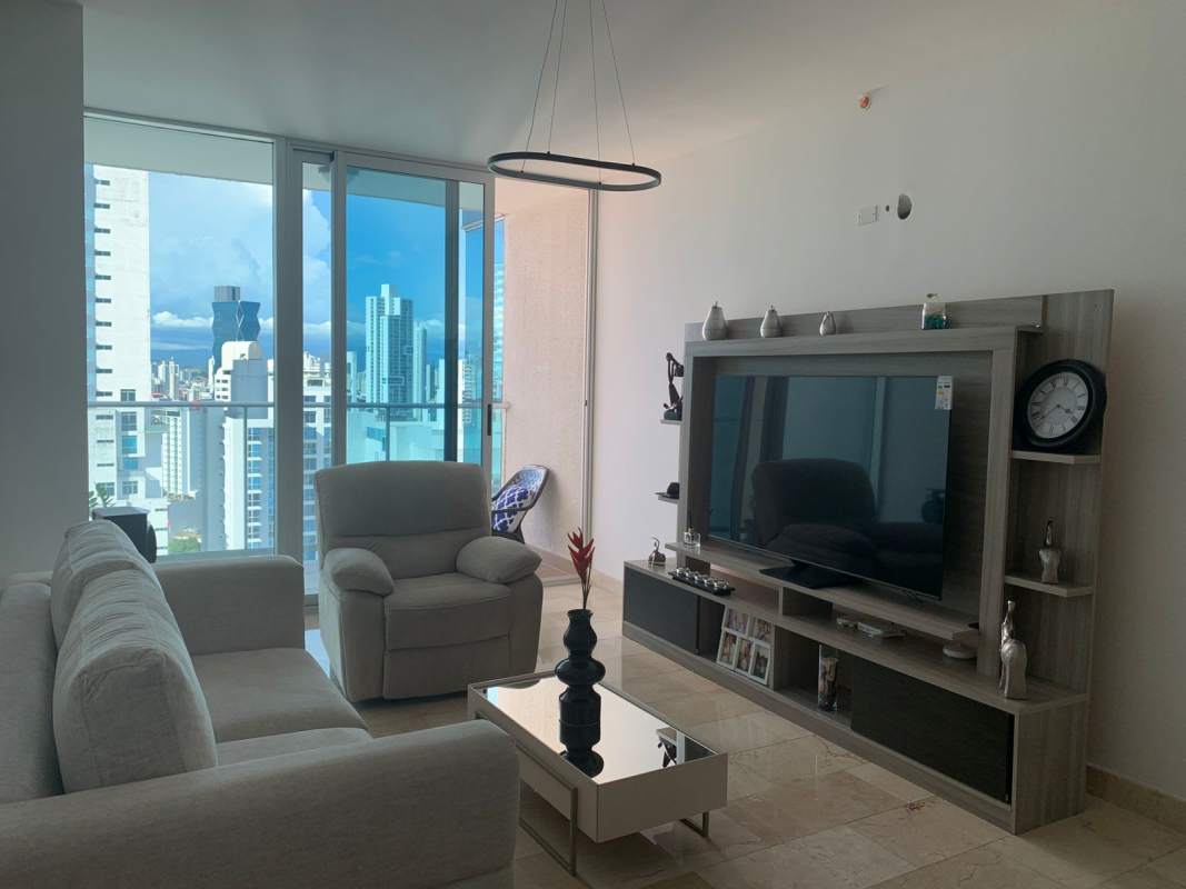 Bright living room with floor-to-ceiling windows showing skyline view PH Dynasty Tower Panama City
