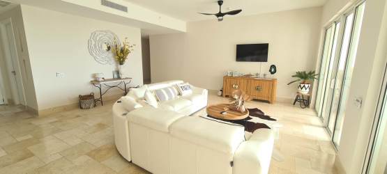 Bright living room with large windows overlooking terrace and ocean in Buenaventura Resort Panama