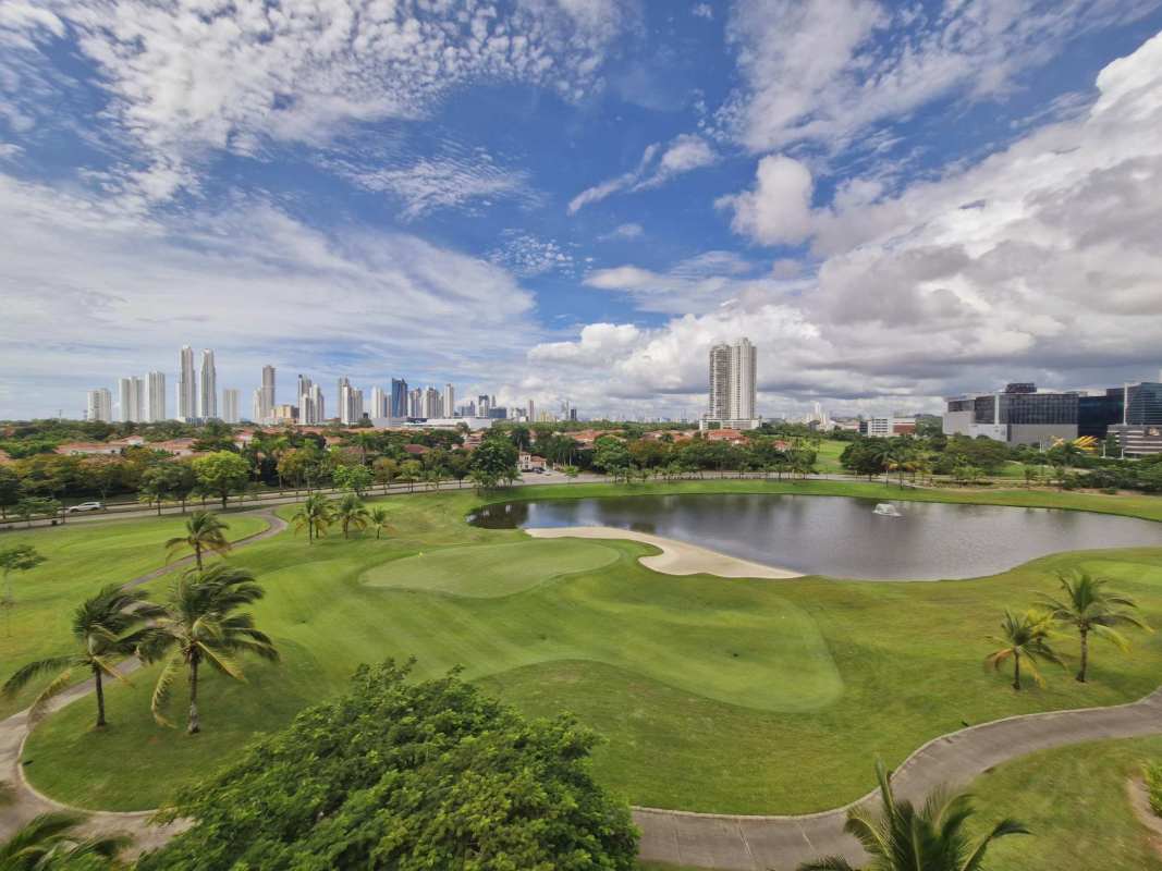 Panoramic aerial view of Santa María Golf Course, lake and Panama City skyline from penthouse at The Reserve