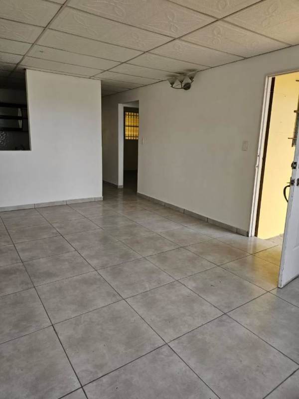Large living room with white ceramic tiles and drop ceiling in residential house Camino Real Panama