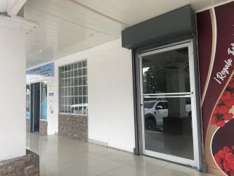 Accessible glass door entrance with tile sidewalk at Plaza Don Pablo Bugaba Panama