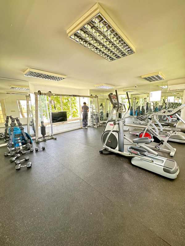 Fully equipped modern gym with cardio and weight machines in Villa Alta Brisas del Golf community
