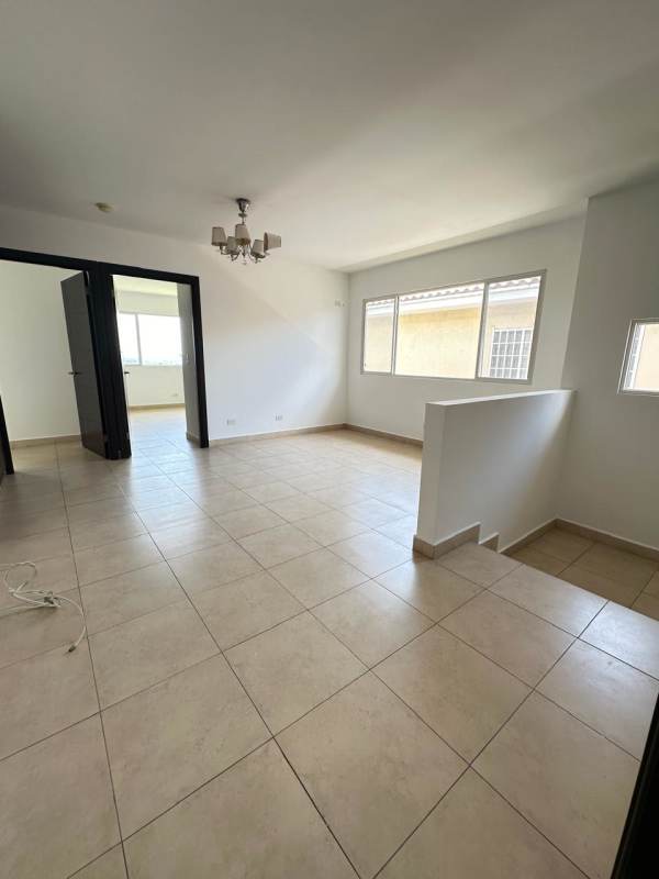 Spacious bright living room with tile floors and chandelier at Villa Alta Panama
