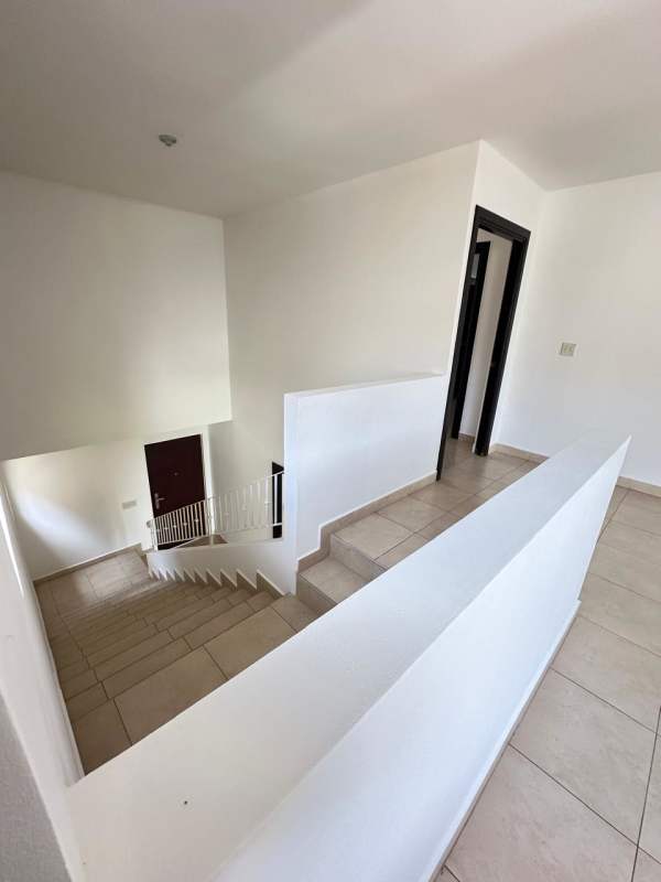 Bright two-story interior with stairway and open hallway in Villa Alta house Brisas del Golf Panama