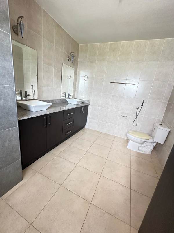 Spacious bathroom with double sinks, mirrors, and modern fixtures Villa Alta Brisas del Golf