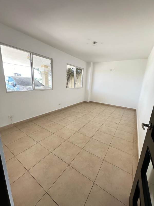 Spacious empty room with large windows and tile floors at Villa Alta Brisas del Golf