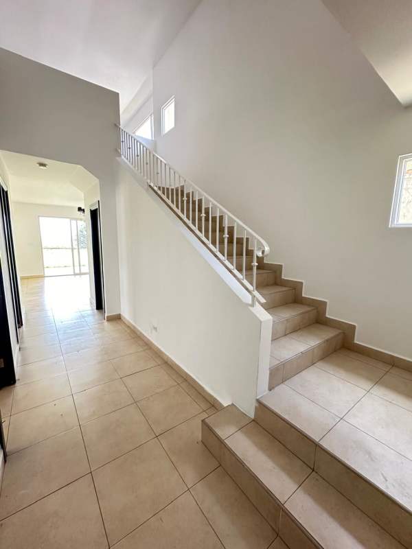 Interior hallway with tile staircase and natural light in Villa Alta Brisas del Golf house