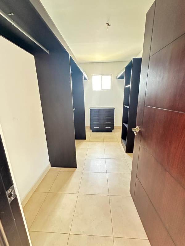 Spacious walk-in closet with shelves and natural light in Panama house Villa Alta Brisas del Golf