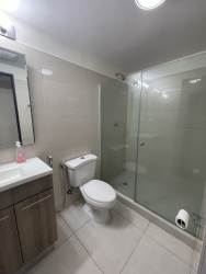 Double sink bathroom modern finishes glass walk-in shower Woodlands Midrise Panama Pacifico