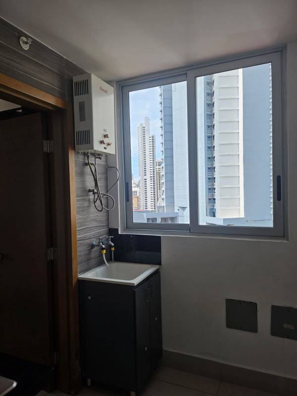 Laundry room with large window, water heater and cityscape backdrop PH Park City Panama