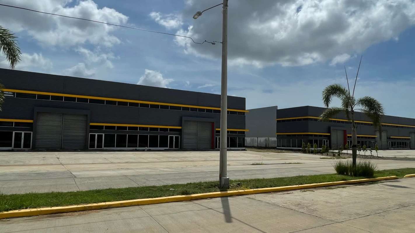 Wide industrial warehouse complex with parking, roll-up doors and landscaping in Panama City