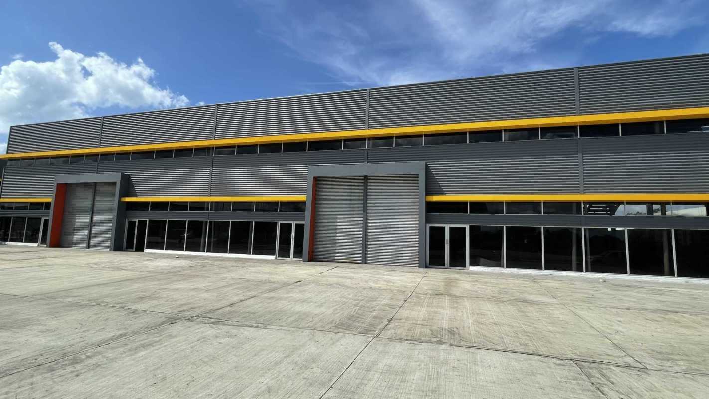 Contemporary warehouse facade in Panama City with office showroom and industrial doors