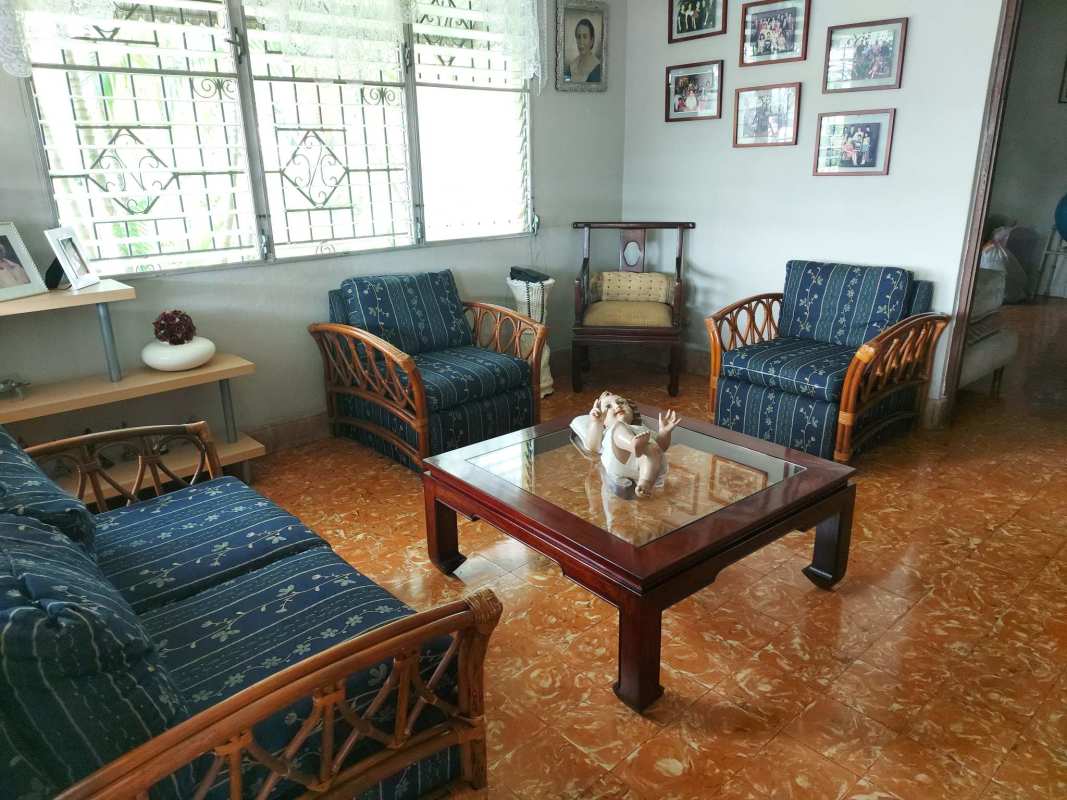 Living room with blue sofas in spacious home for sale Miraflores Betania