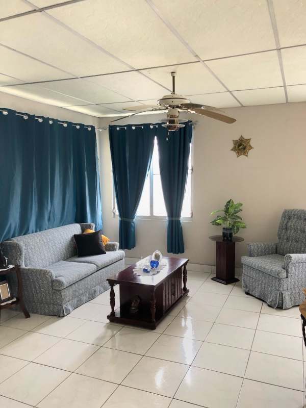 Minimalist bedroom with window and ceiling fan in two households lot near El Dorado Panama